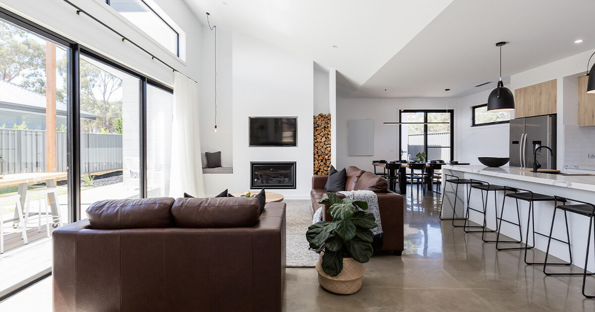 Modern open concept living room with polished concrete flooring.